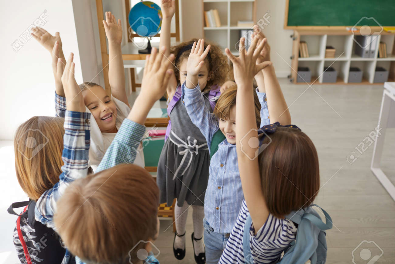 Group Of Enthusiastic Children So Glad To Be Back To School Standing In  Circle With Hands Up And Shouting Hurray. Yay, Schools Out For Summer. Kids  Having Fun In Classroom After Last, image size:1300x867