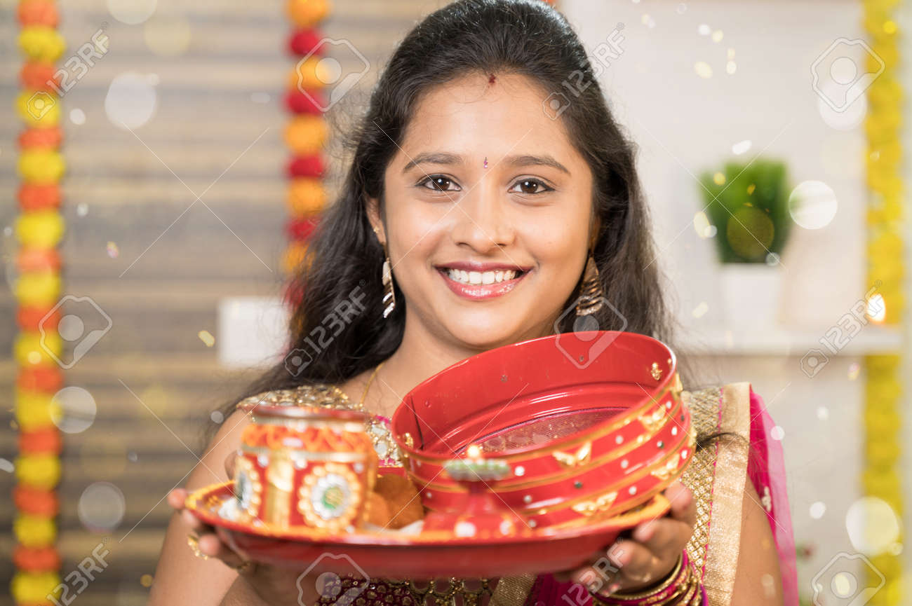 Close Up POV Shot Of Indian Married Woman In Traditional Dress Holding  Karva Chauth Thali Or Plate And Looking Into Camera During Indian Religious  Karwa Chauth Festival. Stock Photo, Picture And Royalty