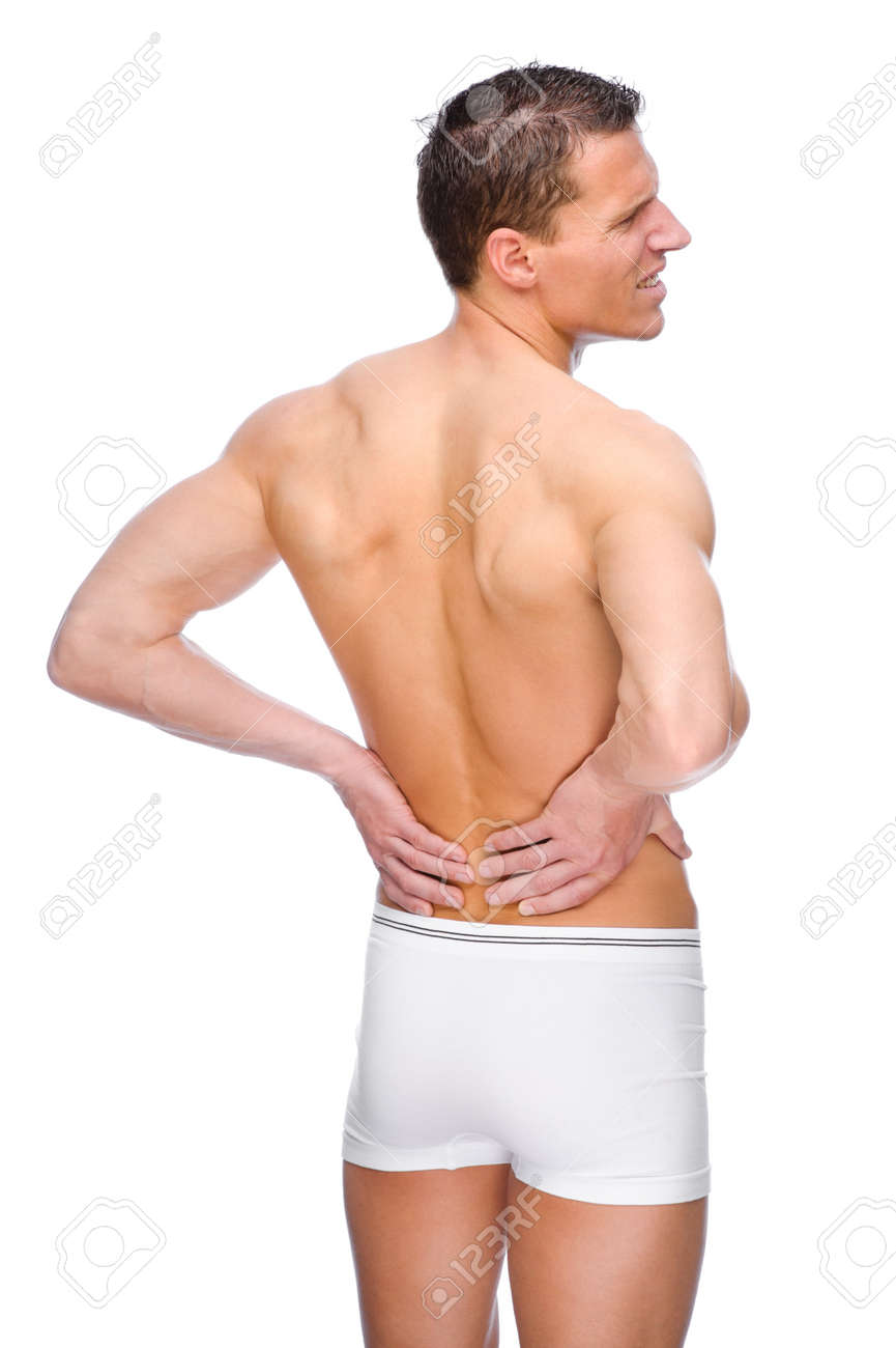 背中の痛みを持つ若い裸の男から完全に分離されたスタジオ画像 の写真素材 画像素材 Image