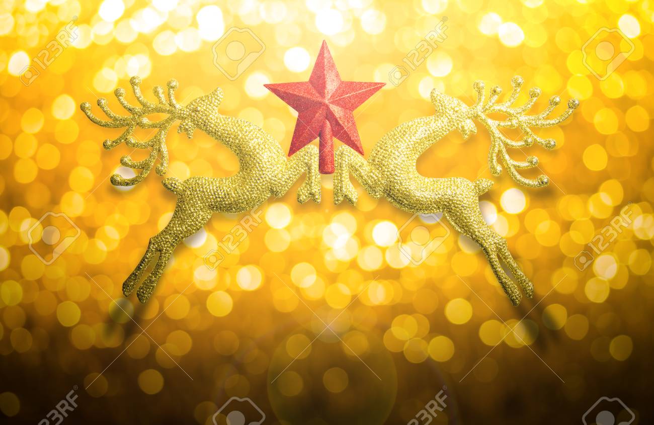 Two Golden Reindeer With Red Star On Circular Bokeh Yellow Gold