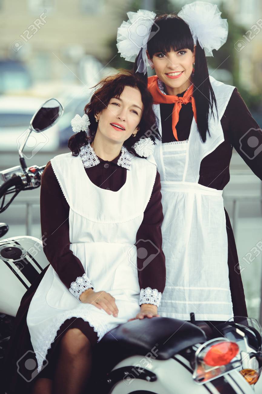 Two Beautiful Young Woman Hairstyle And Bows Outdoors With A