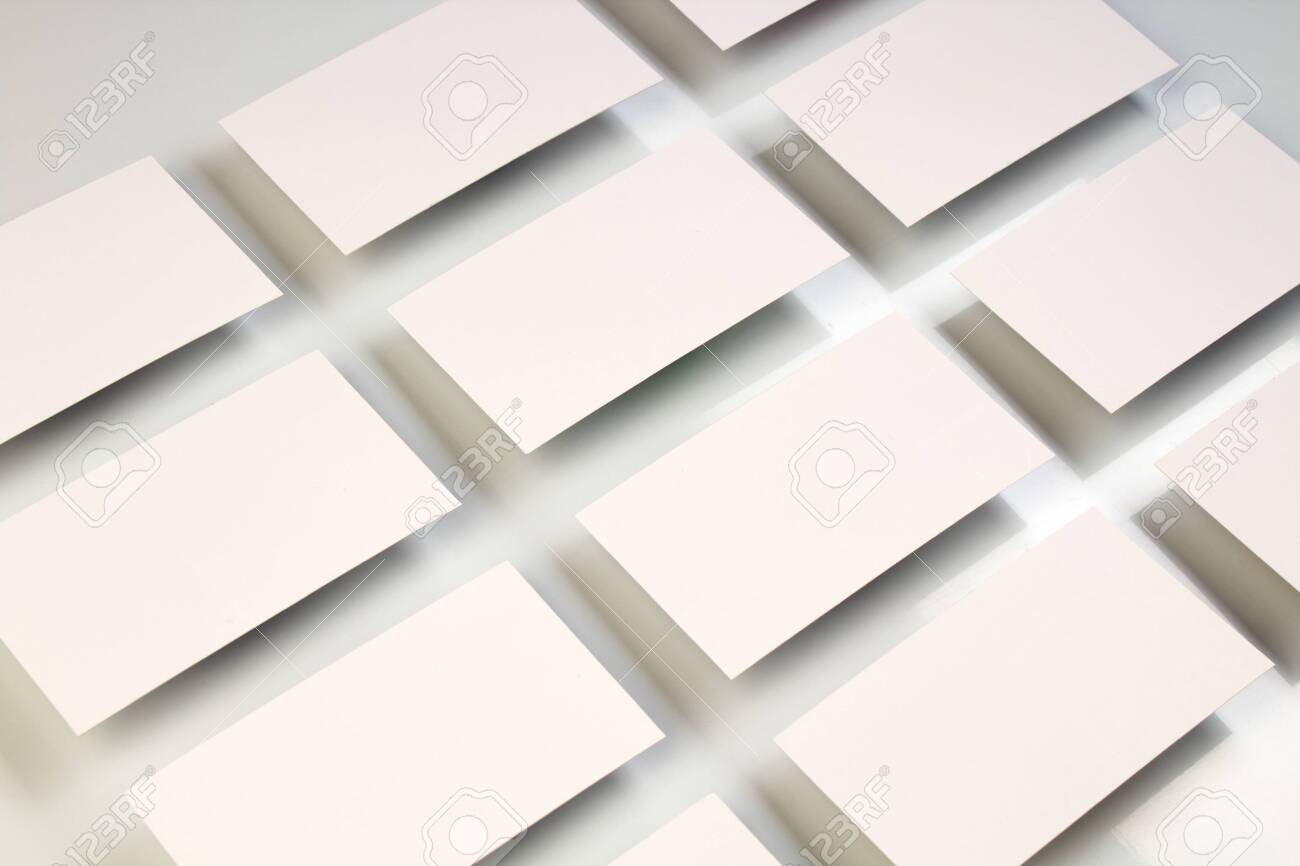 Mockup of horizontal business cards stacks arranged in rows at white textured paper background. - 122962429 Mockup of horizontal business cards stacks arranged in rows at white textured paper background. - 122962429