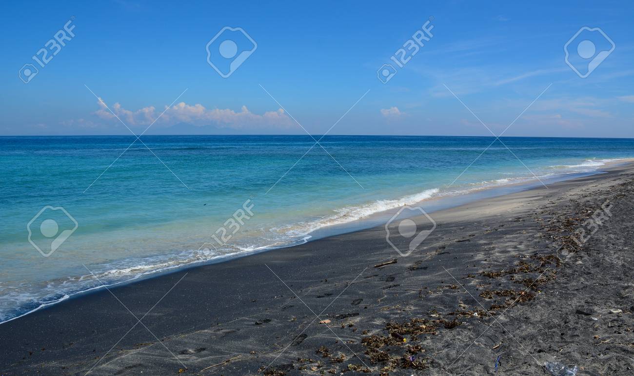 Black Sand Beach With Blue Sea At Summer On Lombok Island Indonesia - 