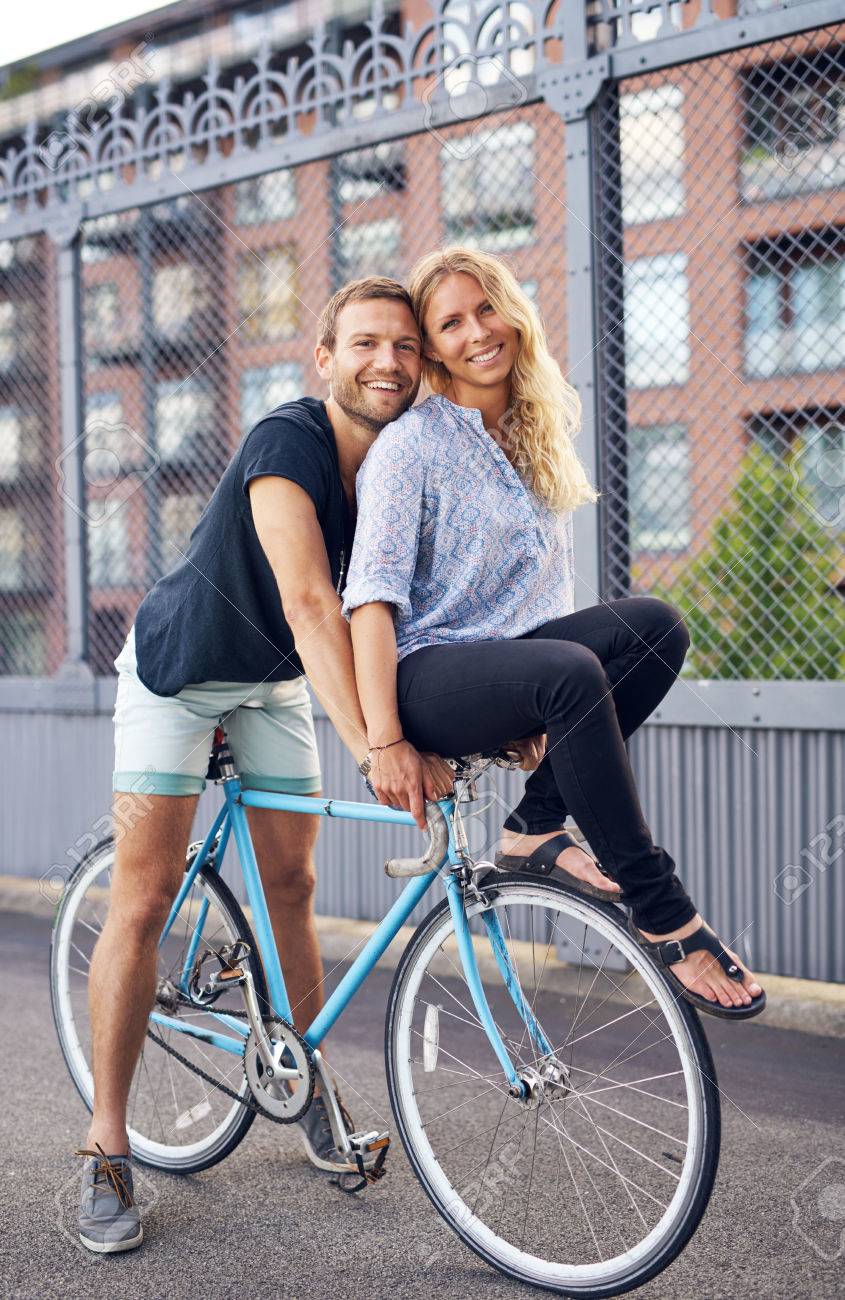 riding on the handlebars of a bike