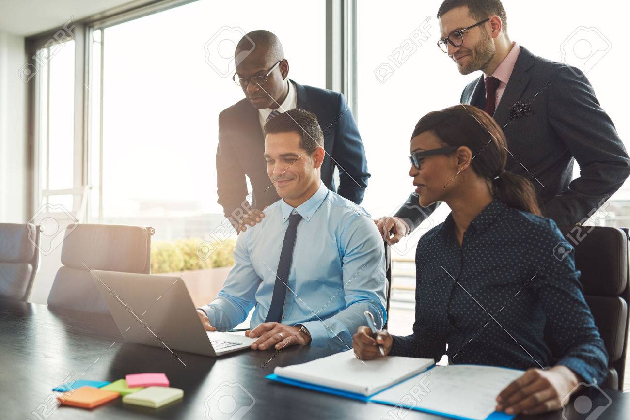 Group of happy diverse male and female business people in formal gathered around laptop computer in bright office - 56414850 Group of happy diverse male and female business people in formal gathered around laptop computer in bright office - 56414850
