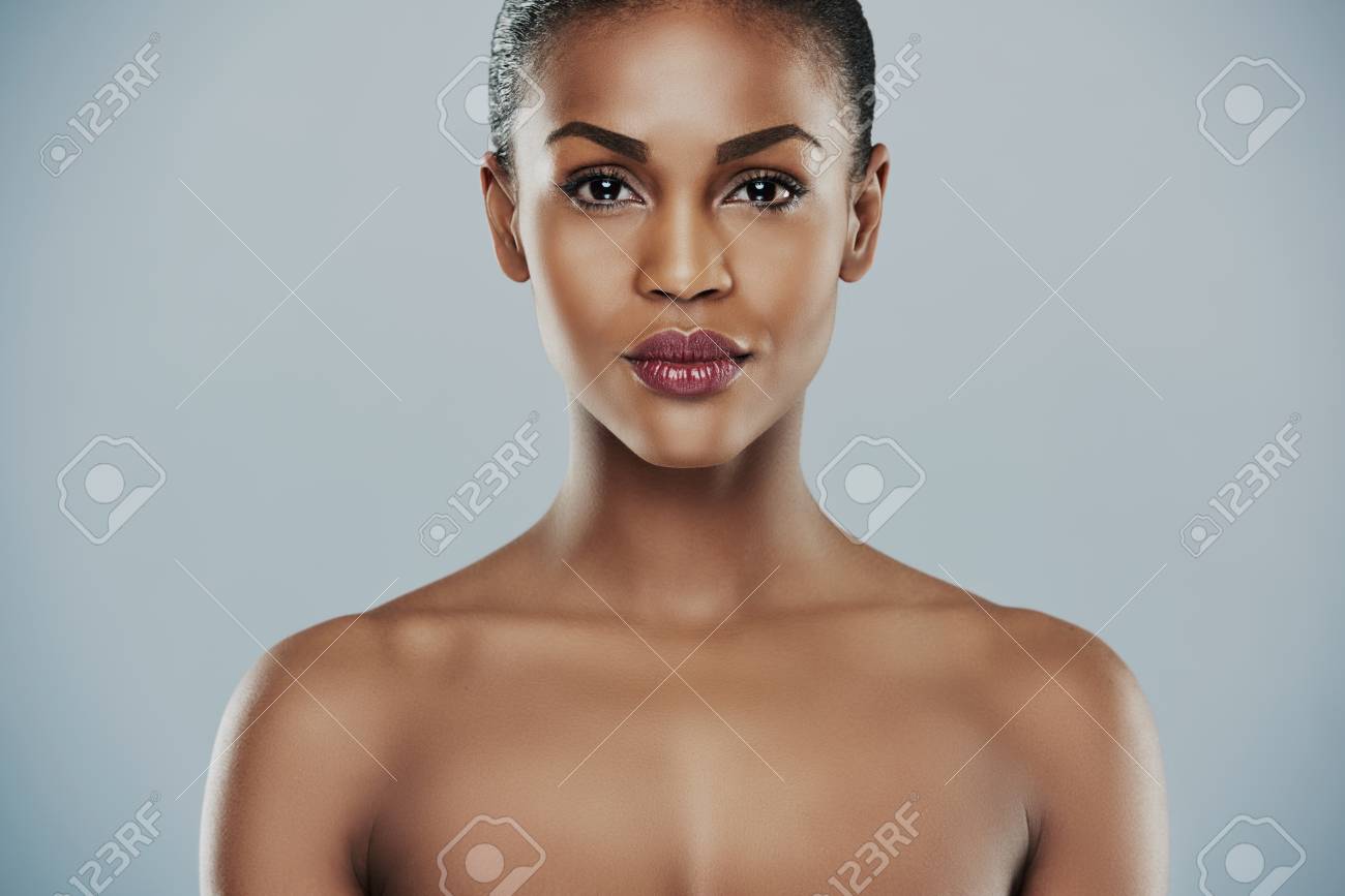 Front View Of Beautiful African Woman Model With Calm Expression And Bare  Shoulders Over Gray Background With Copy Space Stock Photo, Picture and  Royalty Free Image. Image 56414862.