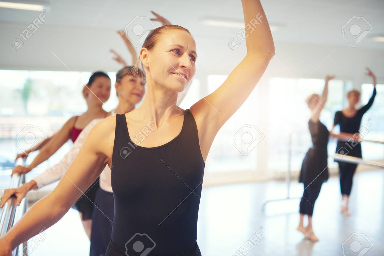 Smiling Adult Woman Standing With Hand Up And Looking Away Smiling Adult Woman Standing With Hand Up And Looking Away