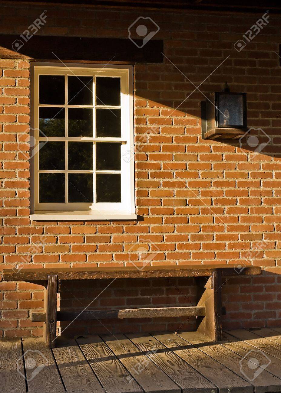 A Wooden Bench White Paned Window And A Brick Wall In Front Stock Photo Picture And Royalty Free Image Image 3124592
