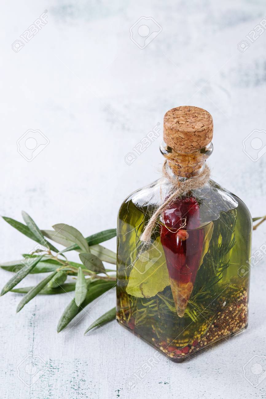 https://previews.123rf.com/images/larryratt/larryratt1610/larryratt161000339/65353961-glass-bottle-of-spicy-olive-oil-with-rosemary-red-hot-chili-peppers-and-bay-leaf-standing-with.jpg