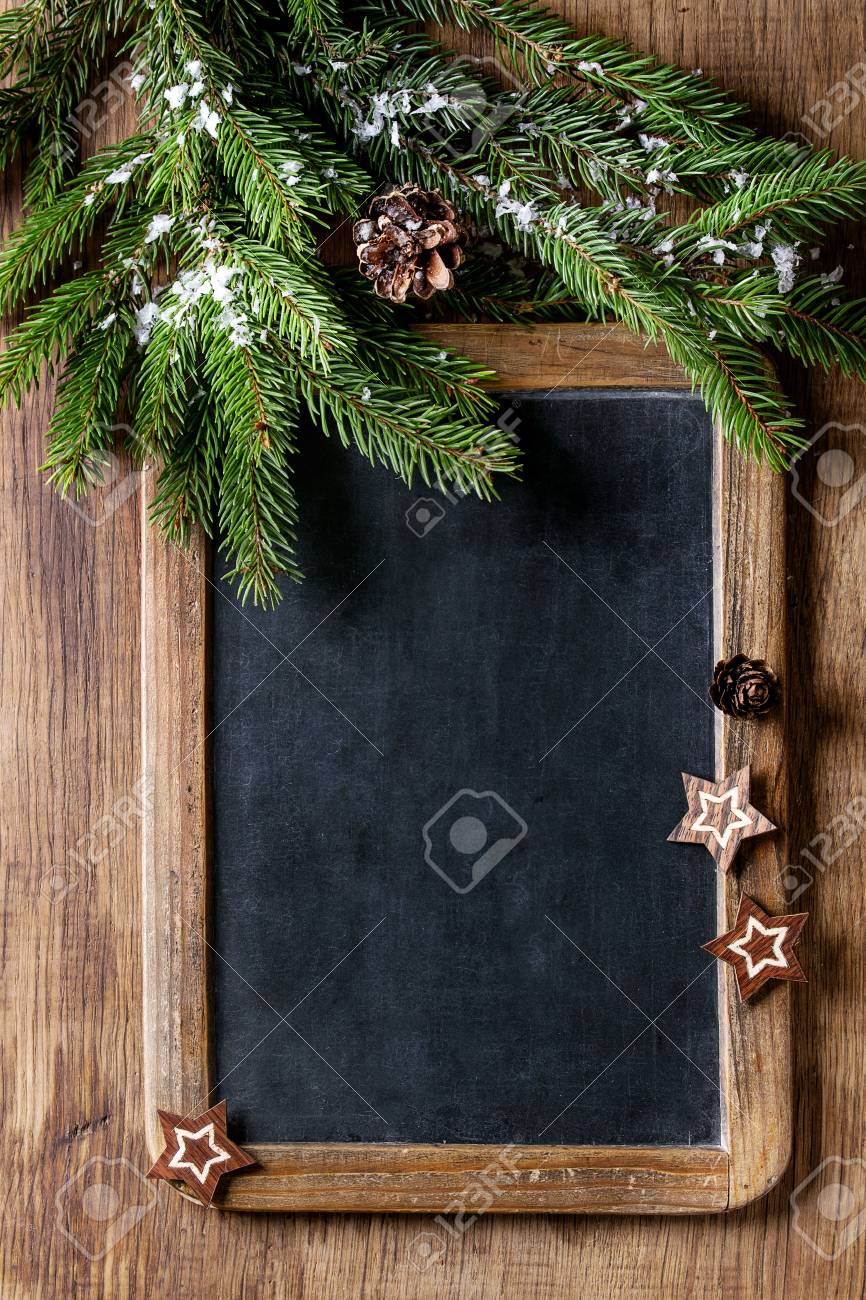 Vintage empty chalkboard with fir Christmas tree and wood modern decor stars over wooden background. Top view with space for text - 87247162 Vintage empty chalkboard with fir Christmas tree and wood modern decor stars over wooden background. Top view with space for text - 87247162