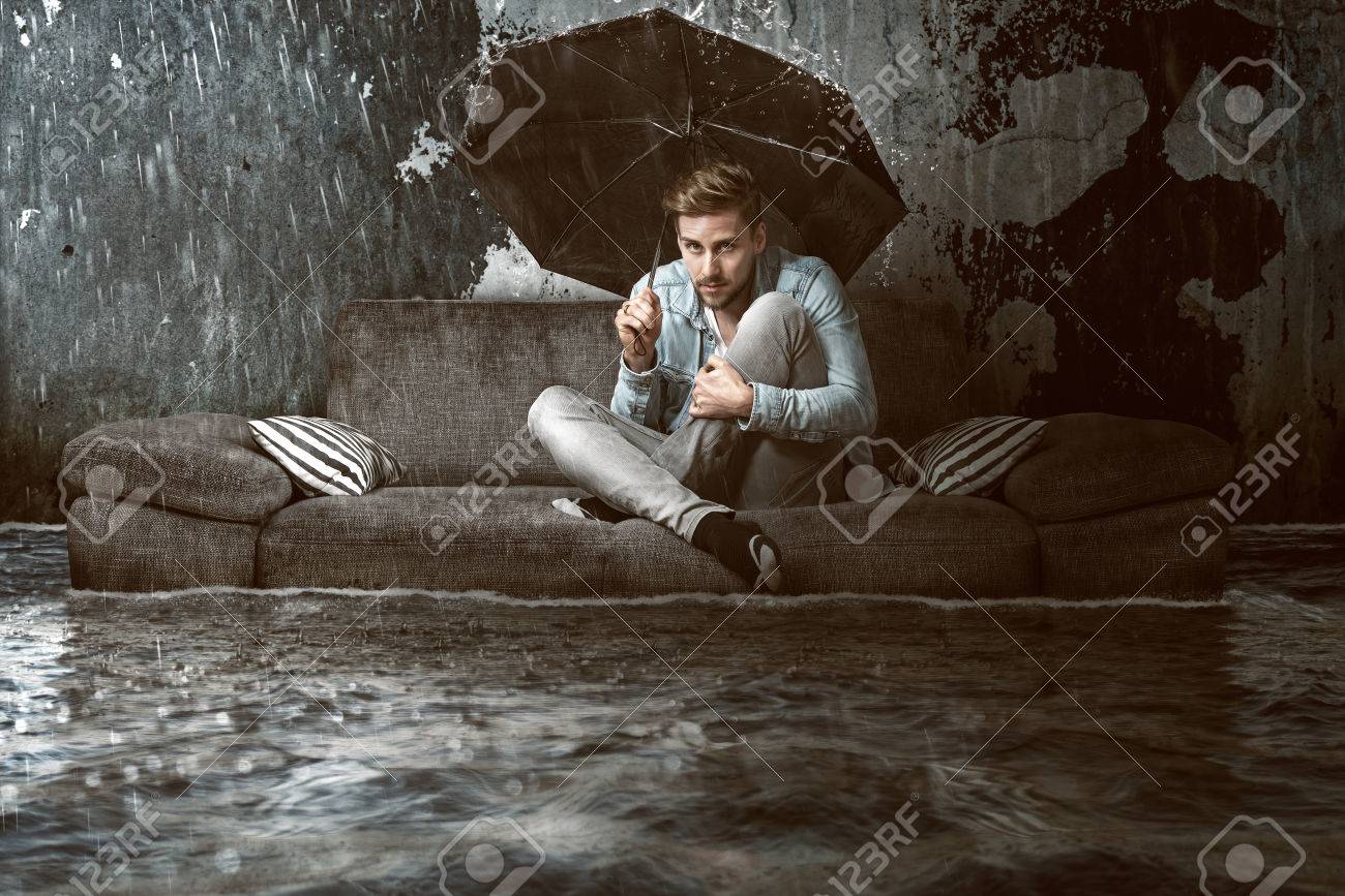 Man in his flooded flat - 76974374 Man in his flooded flat - 76974374