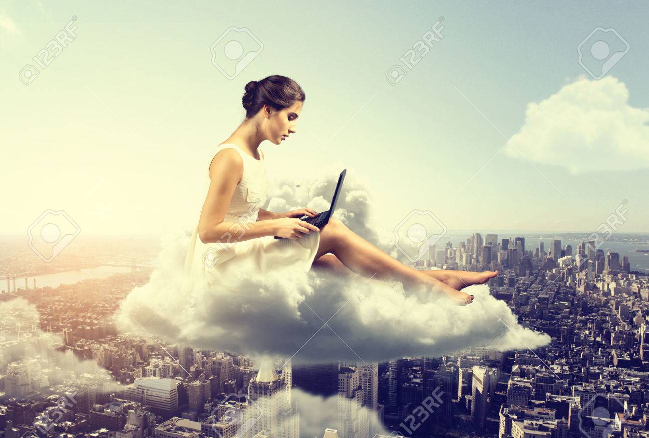 Woman working o a cloud above the city - 77466335 Woman working o a cloud above the city - 77466335