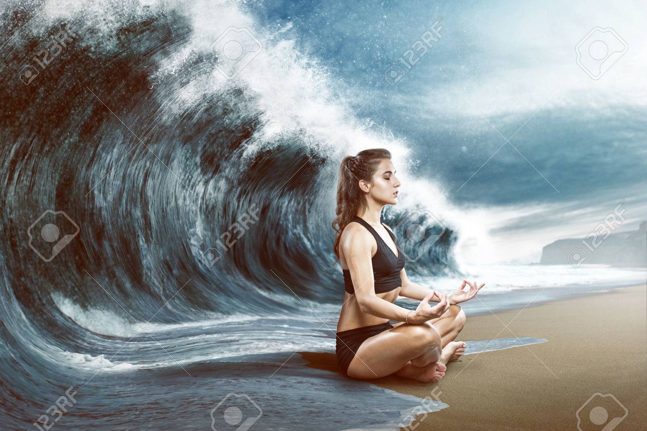 Woman relaxes in front of big wave - 77466838 Woman relaxes in front of big wave - 77466838