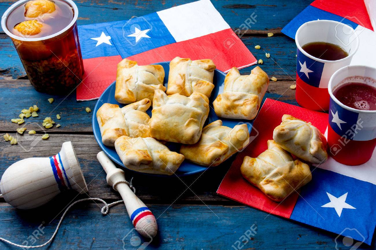 Chilean independence day concept. fiestas patrias. Chilean typical dish and drink on independence day party, 18 september. Mini empanadas, mote con huesillo, wine with toasted flour, chicha and tipical play emboque - 84704058 Chilean independence day concept. fiestas patrias. Chilean typical dish and drink on independence day party, 18 september. Mini empanadas, mote con huesillo, wine with toasted flour, chicha and tipical play emboque - 84704058