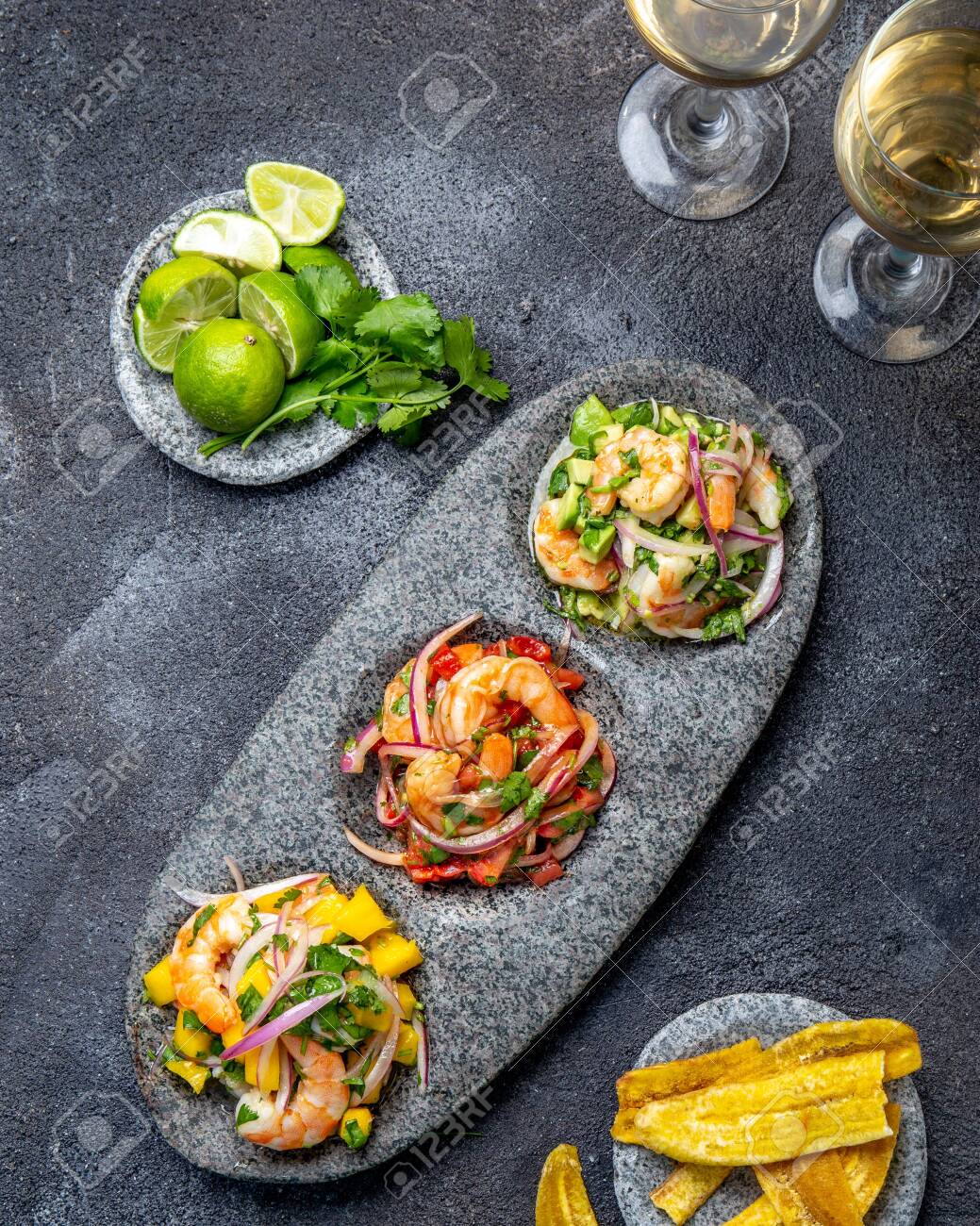 CEVICHE. Three colorful shrimps ceviche with mango, avocado and tomatoes. Latin American Mexican Peruvian Ecuadorian food. Served with white wine and banana chips - 137085277 CEVICHE. Three colorful shrimps ceviche with mango, avocado and tomatoes. Latin American Mexican Peruvian Ecuadorian food. Served with white wine and banana chips - 137085277