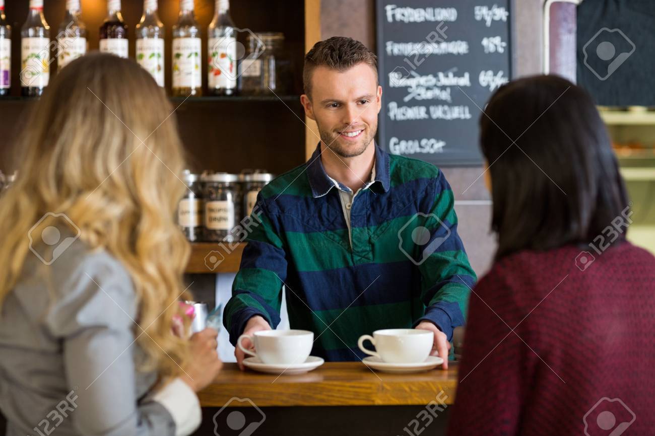 Bartender Serving Coffee To Female Friends At Cafe Stock Photo - Bartender Serving Coffee To Female Friends At Cafe Stock Photo bartender serving coffee to female friends at cafe stock photo - bartender serving coffee to female friends at cafe stock photo