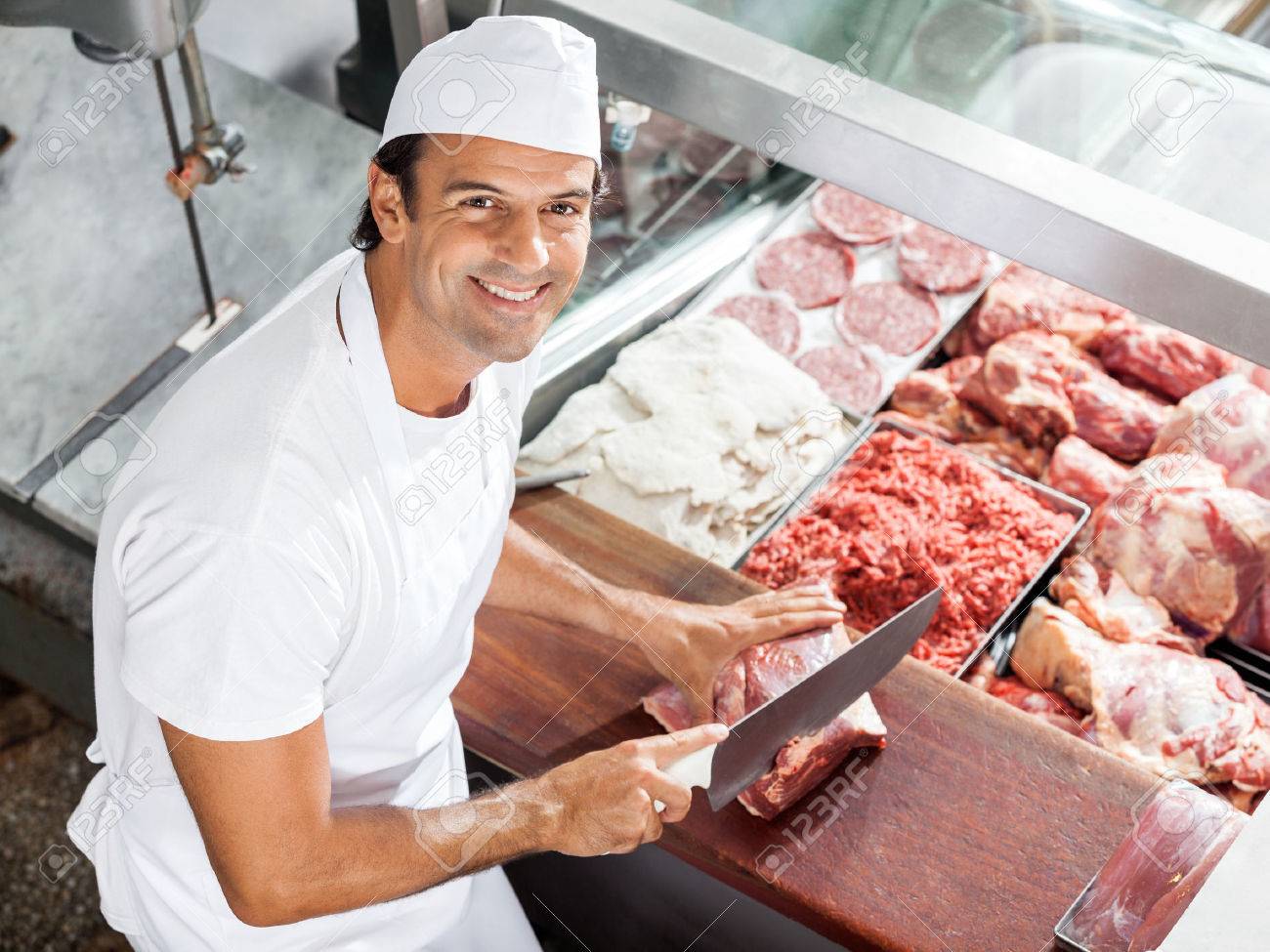 33987271-smiling-butcher-cutting-meat-at-counter.jpg