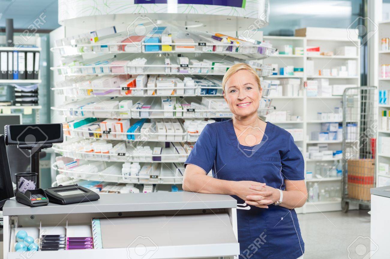 Portrait of confident female pharmacist leaning at cash counter in pharmacy - 43431873 Portrait of confident female pharmacist leaning at cash counter in pharmacy - 43431873