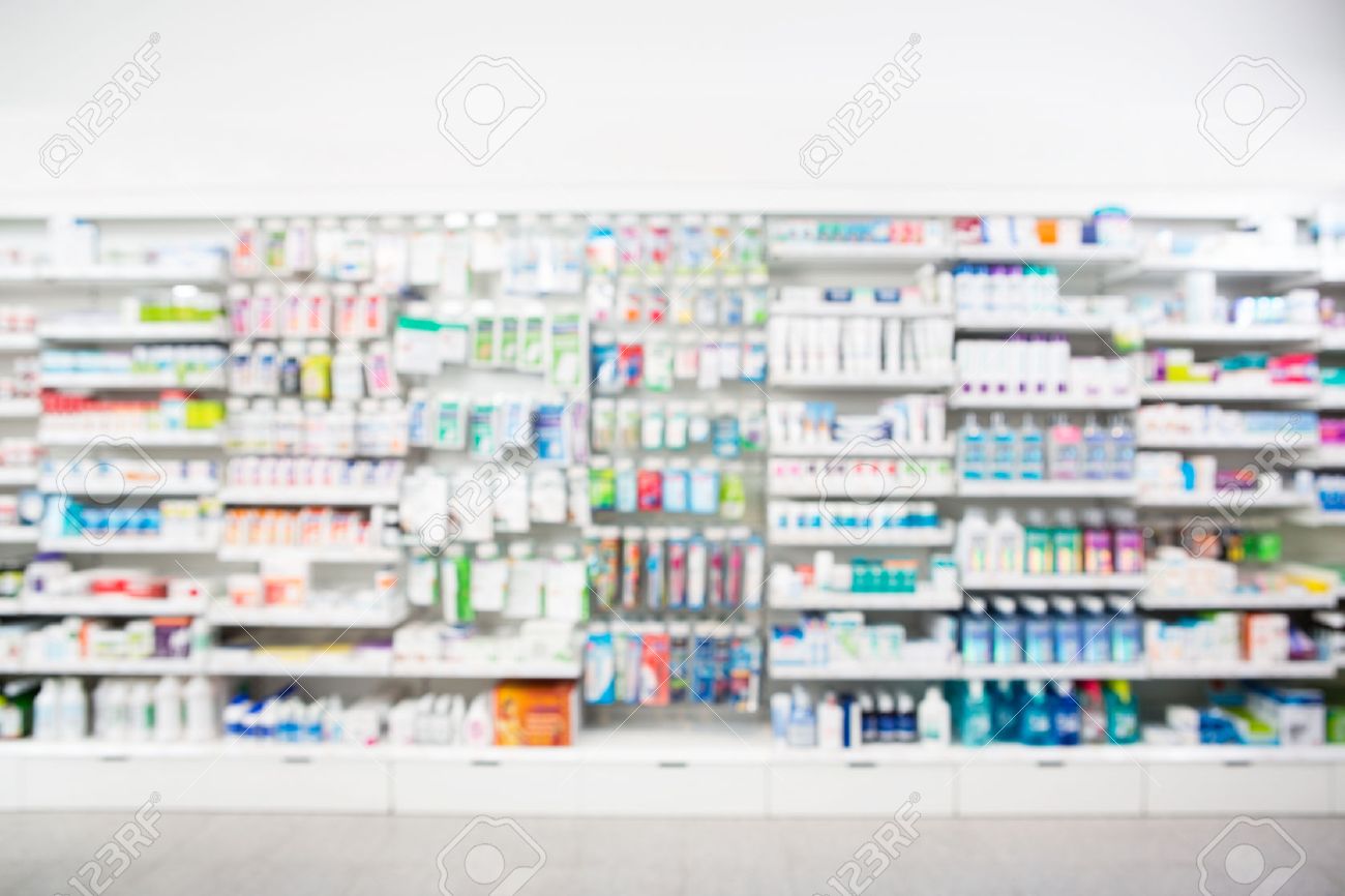 Defocused image of medicines arranged in shelves at pharmacy - 53313442 Defocused image of medicines arranged in shelves at pharmacy - 53313442