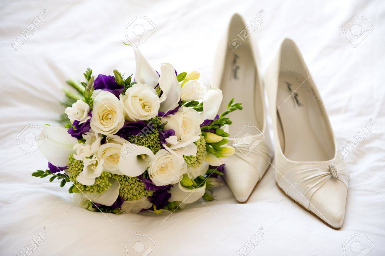 Wedding Shoes And Flowers Of The Bride Stock Photo Picture And