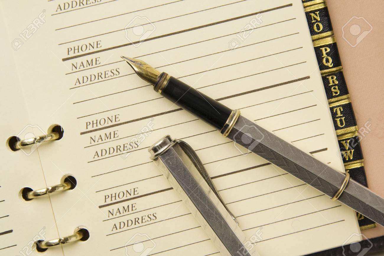 silver fountain pen and leather address book address bok
