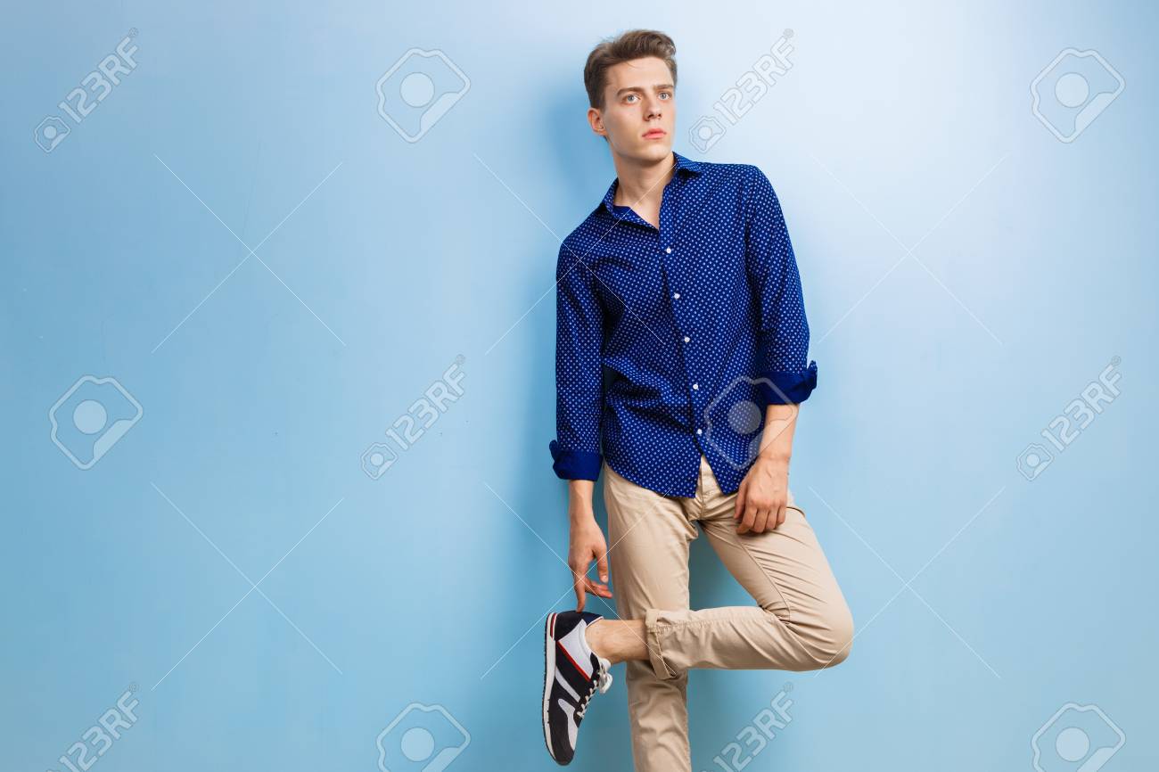 dark blue shirt with beige pants