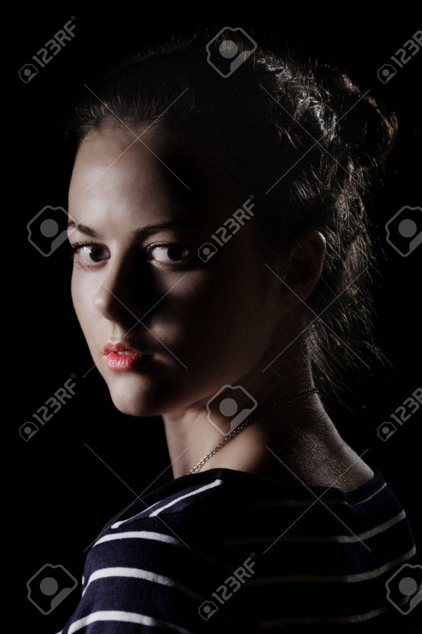 Scared Girl Looking Back On Dark Background Stock Photo, Picture and  Royalty Free Image. Image 14965385.