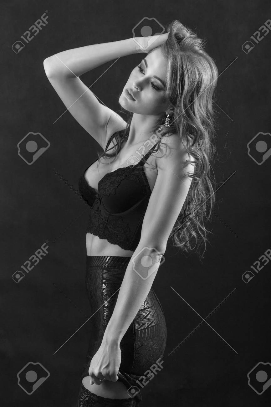 魅惑的な女性の黒の背景は モノクロのセクシーなランジェリーでポーズをとっての側面図 の写真素材 画像素材 Image