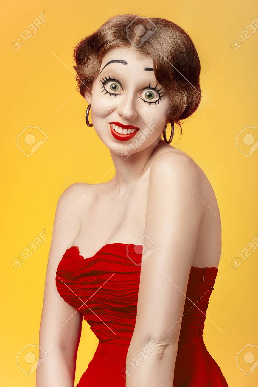 Fun Young Woman With Makeup Making Dolly Face At Camera, Yellow Background Stock Photo, Picture And Royalty Free Image. Image