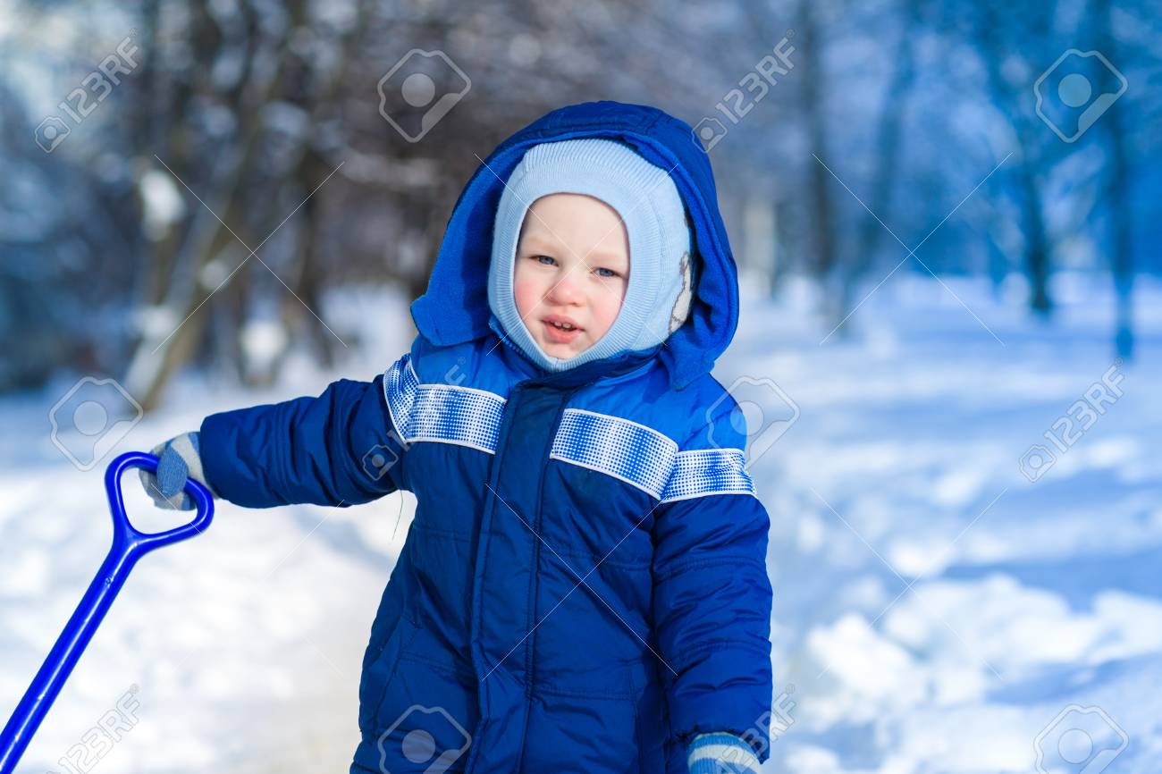 Cute Baby Boy Playing With Snow Toy Shovel In Winter Outdoor Stock
