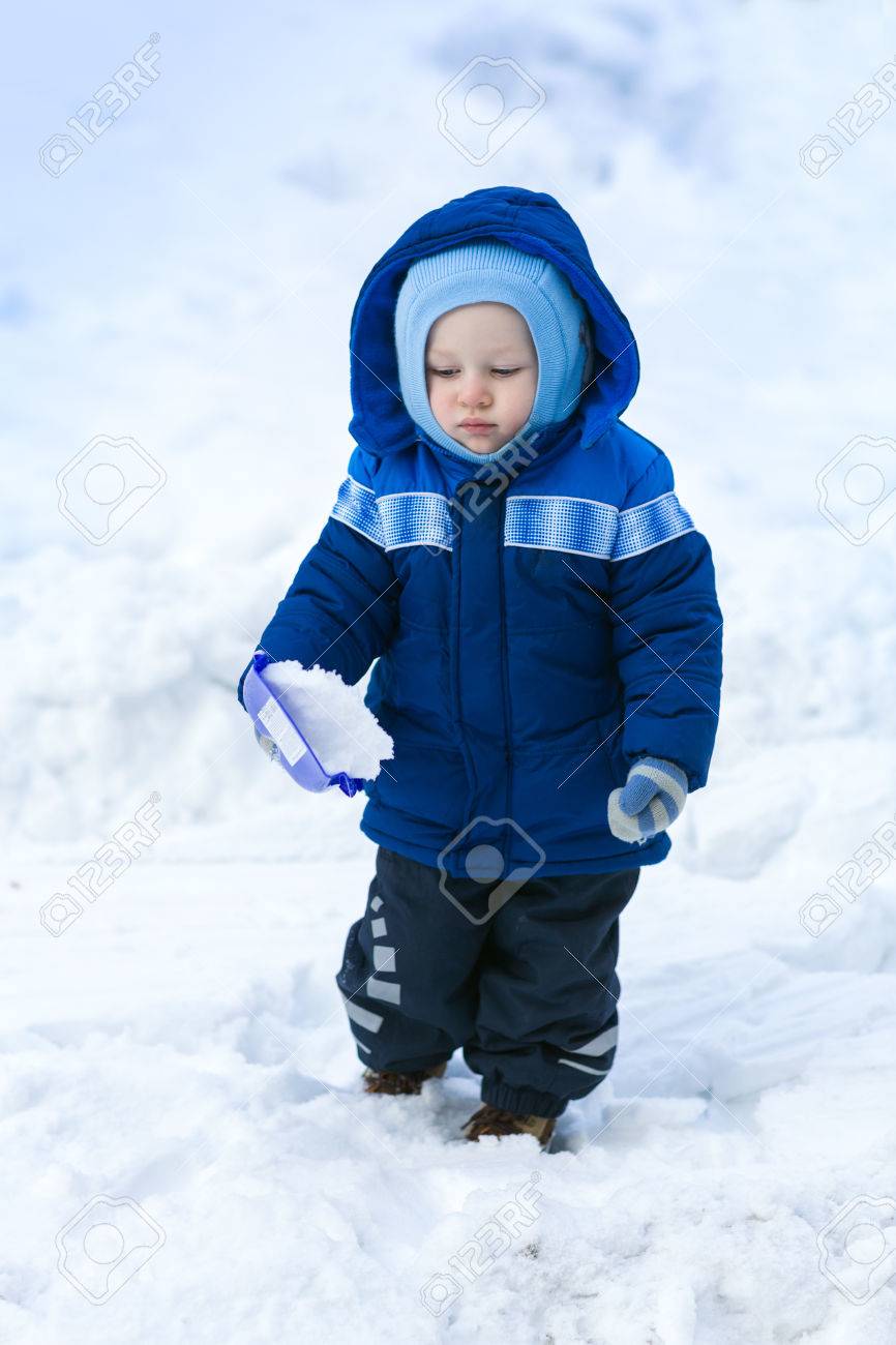 Cute Baby Boy Playing With Snow Toy Shovel In Winter Outdoor Stock