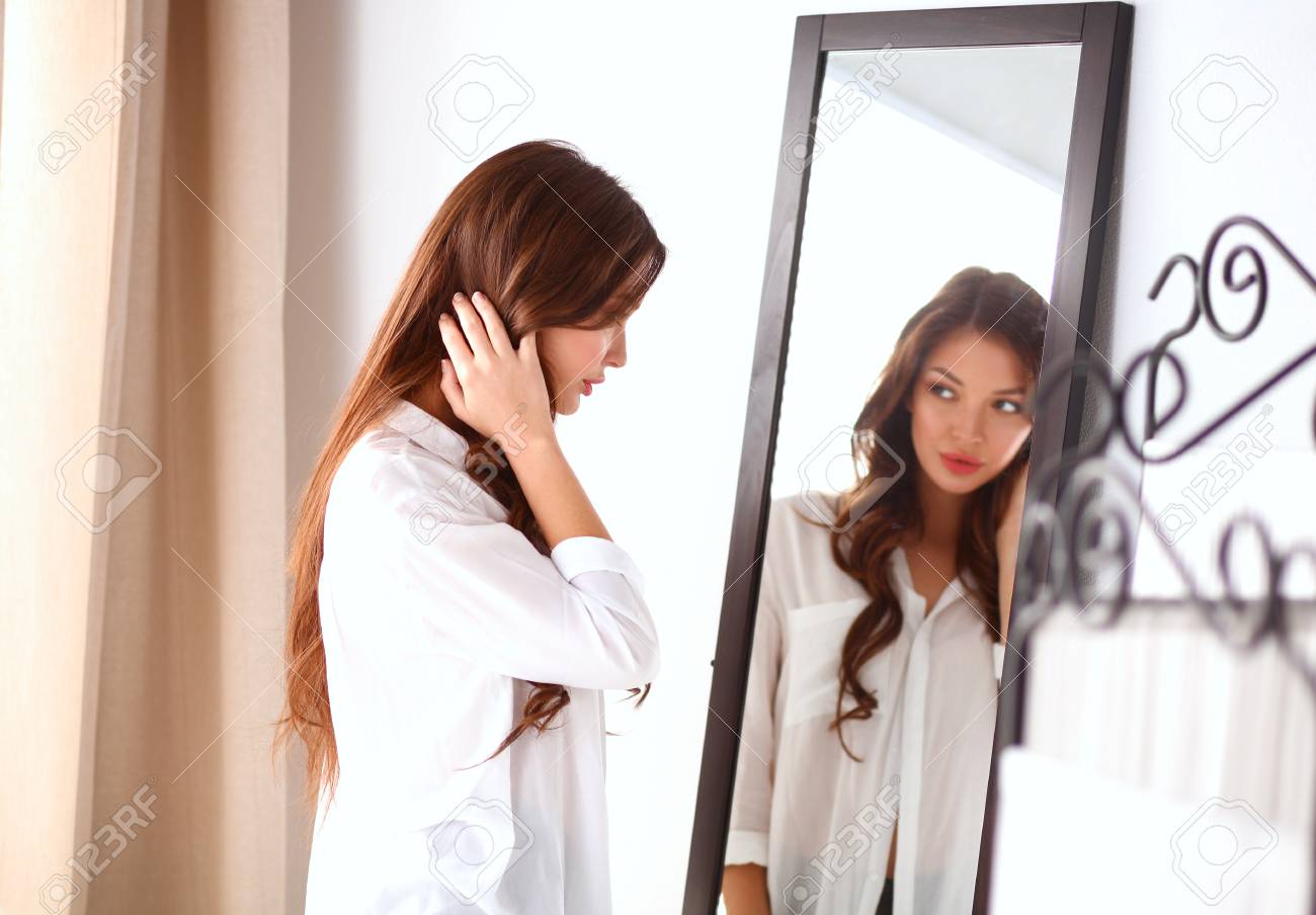 Young Woman Looking Herself Reflection In Mirror At Home Stock Photo,  Picture and Royalty Free Image. Image 72913035., image size:1300x904