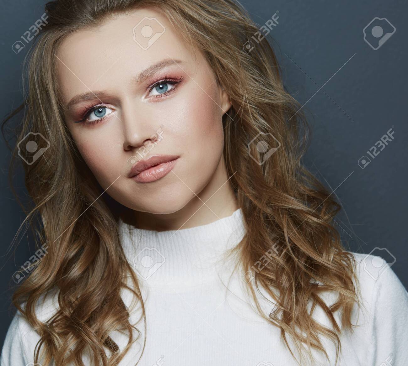 Portrait of beautiful woman model with fresh daily makeup and romantic wavy hairstyle - 140412951 Portrait of beautiful woman model with fresh daily makeup and romantic wavy hairstyle - 140412951