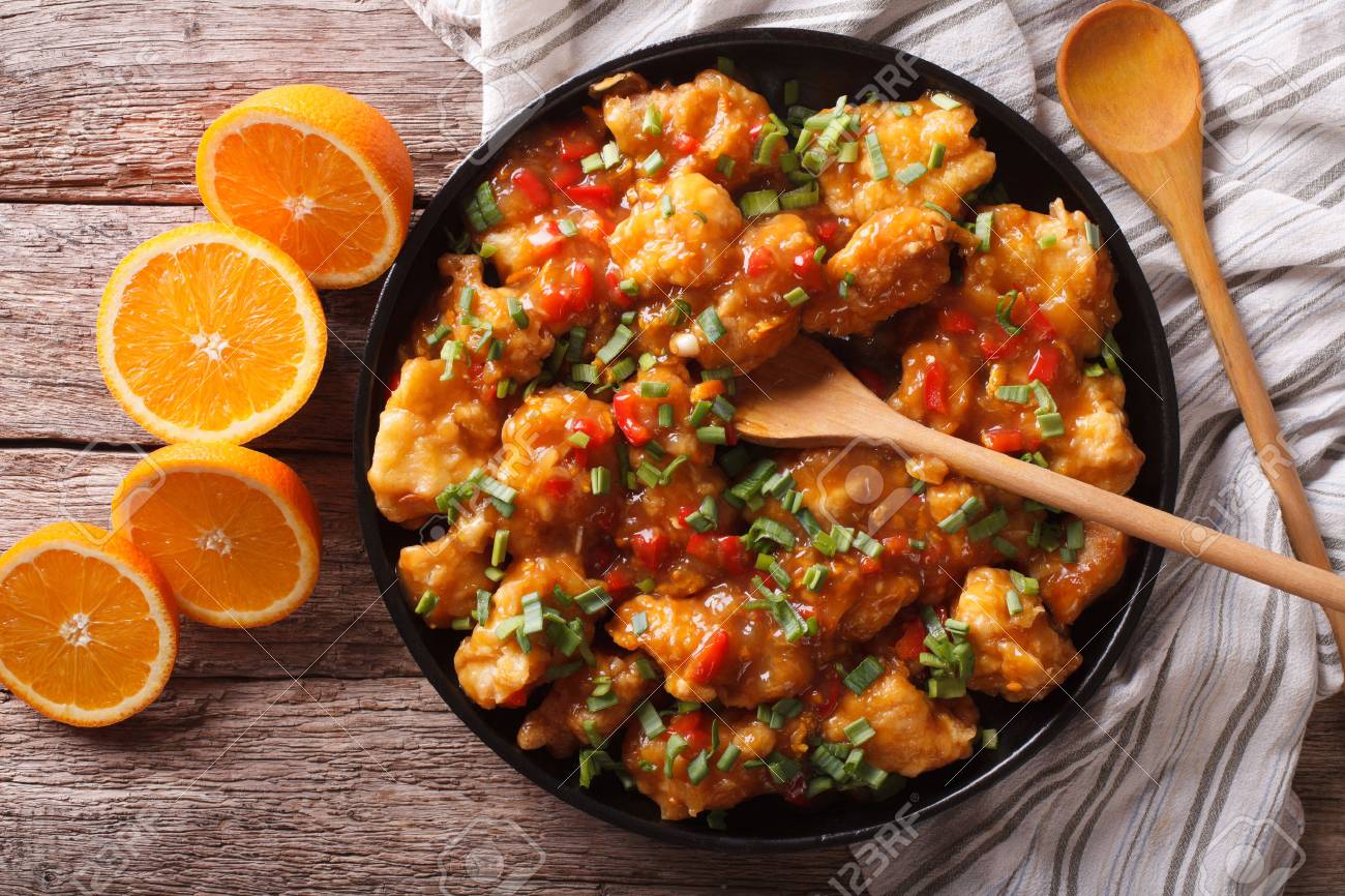 orange chicken in sweet and sour sauce on a plate close-up on the table. horizontal view from above - 53002439 orange chicken in sweet and sour sauce on a plate close-up on the table. horizontal view from above - 53002439