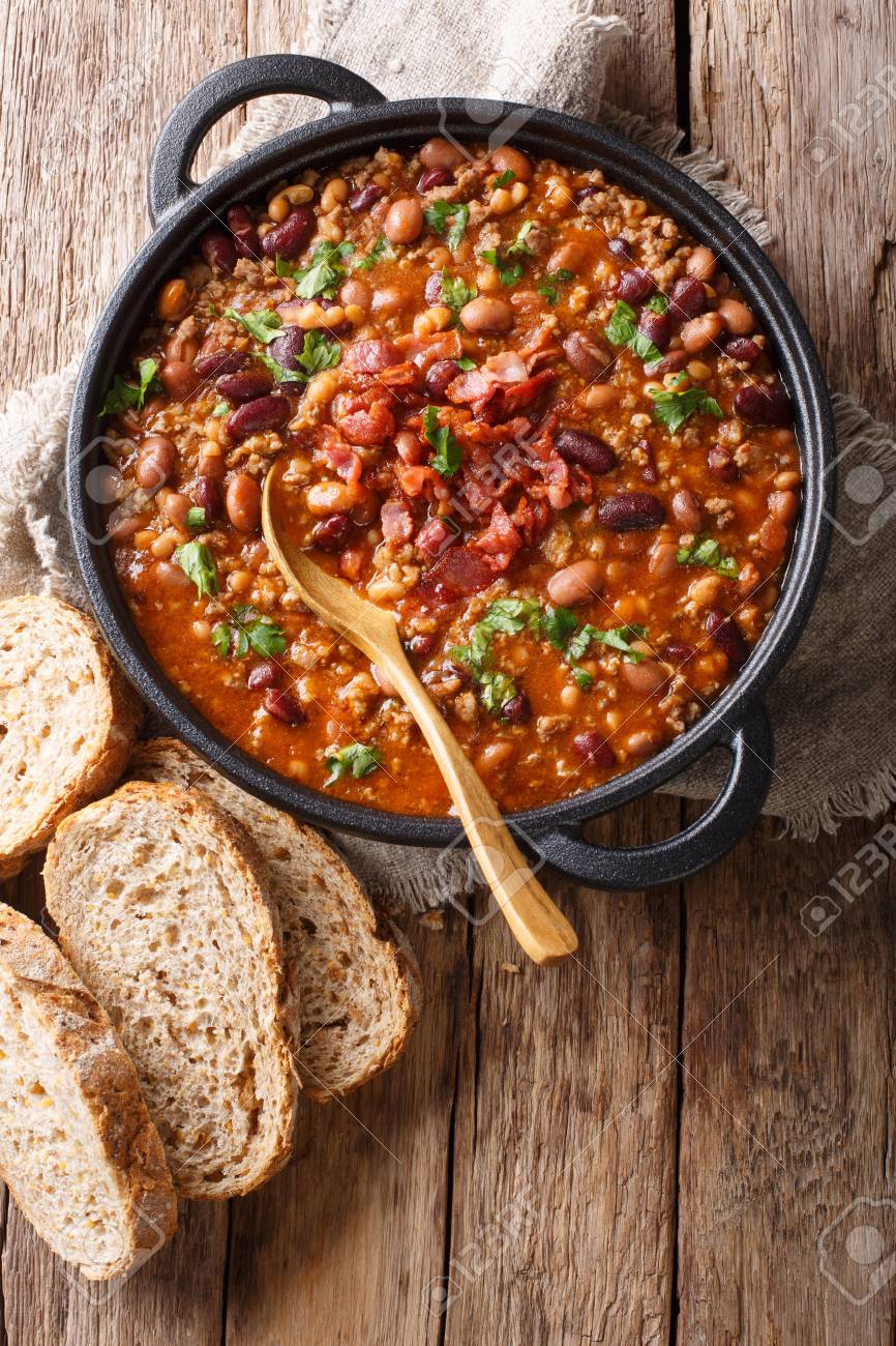 Delicious cowboy stew of beans with ground beef, bacon in a spicy sauce closeup in a bowl on the table. Vertical top view from above - 116481338 Delicious cowboy stew of beans with ground beef, bacon in a spicy sauce closeup in a bowl on the table. Vertical top view from above - 116481338