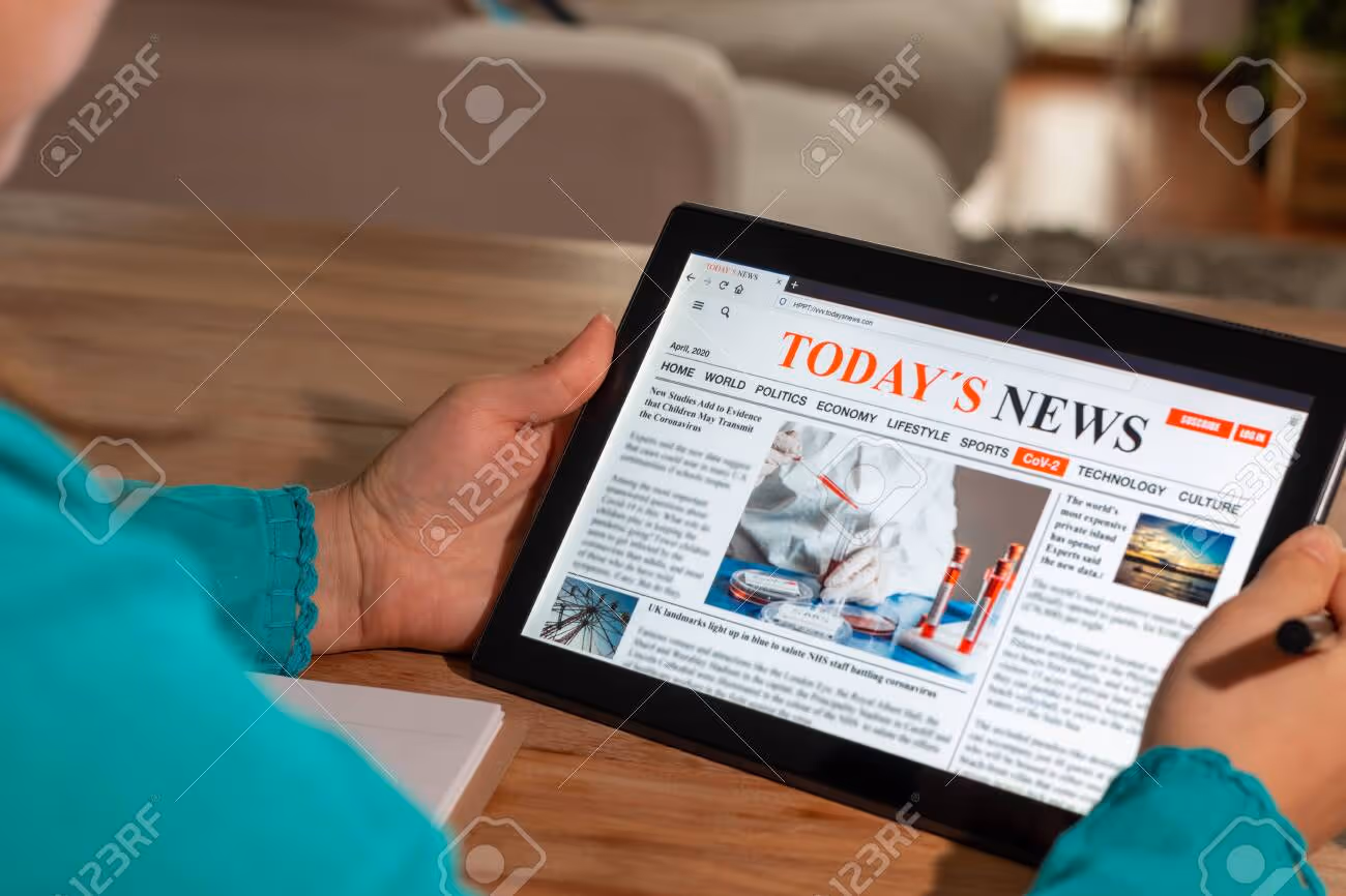 Woman reading the news on a tablet at home. Imaginary online, mobile website, application or news portal on modern touch screen. Take notes in a notebook - 146855144 Woman reading the news on a tablet at home. Imaginary online, mobile website, application or news portal on modern touch screen. Take notes in a notebook - 146855144