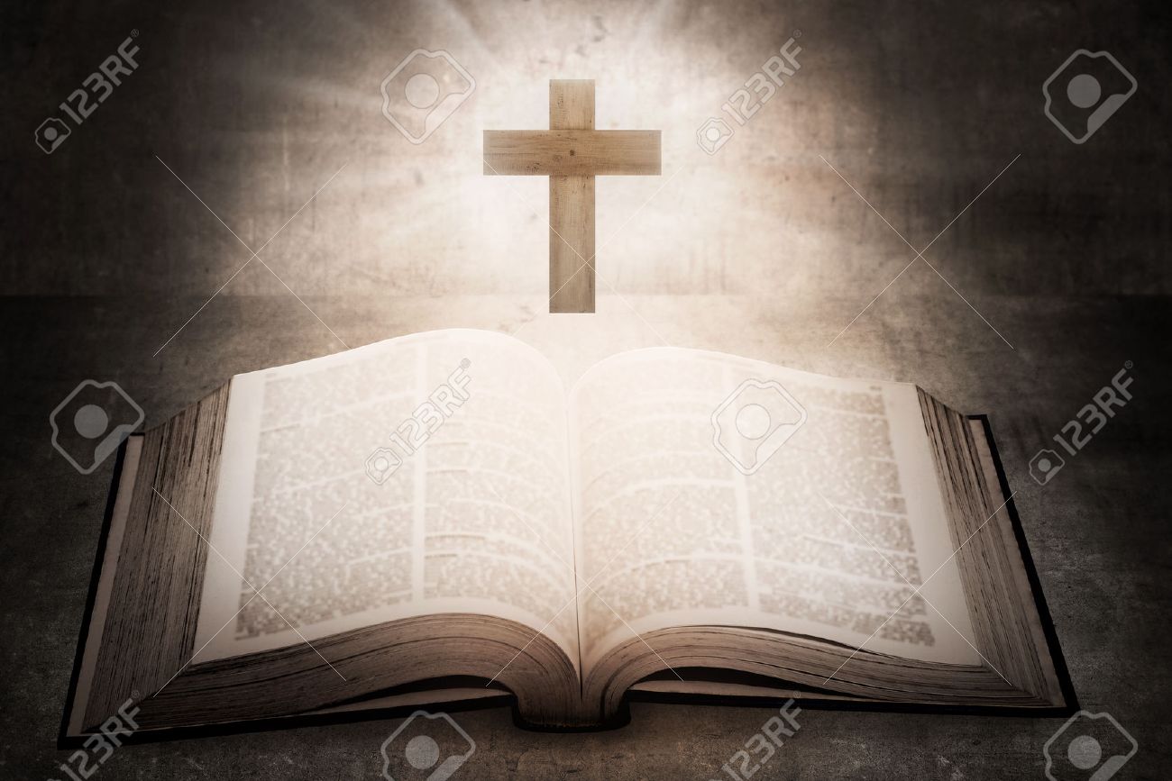 open holy bible with wooden cross in the middle christian concept