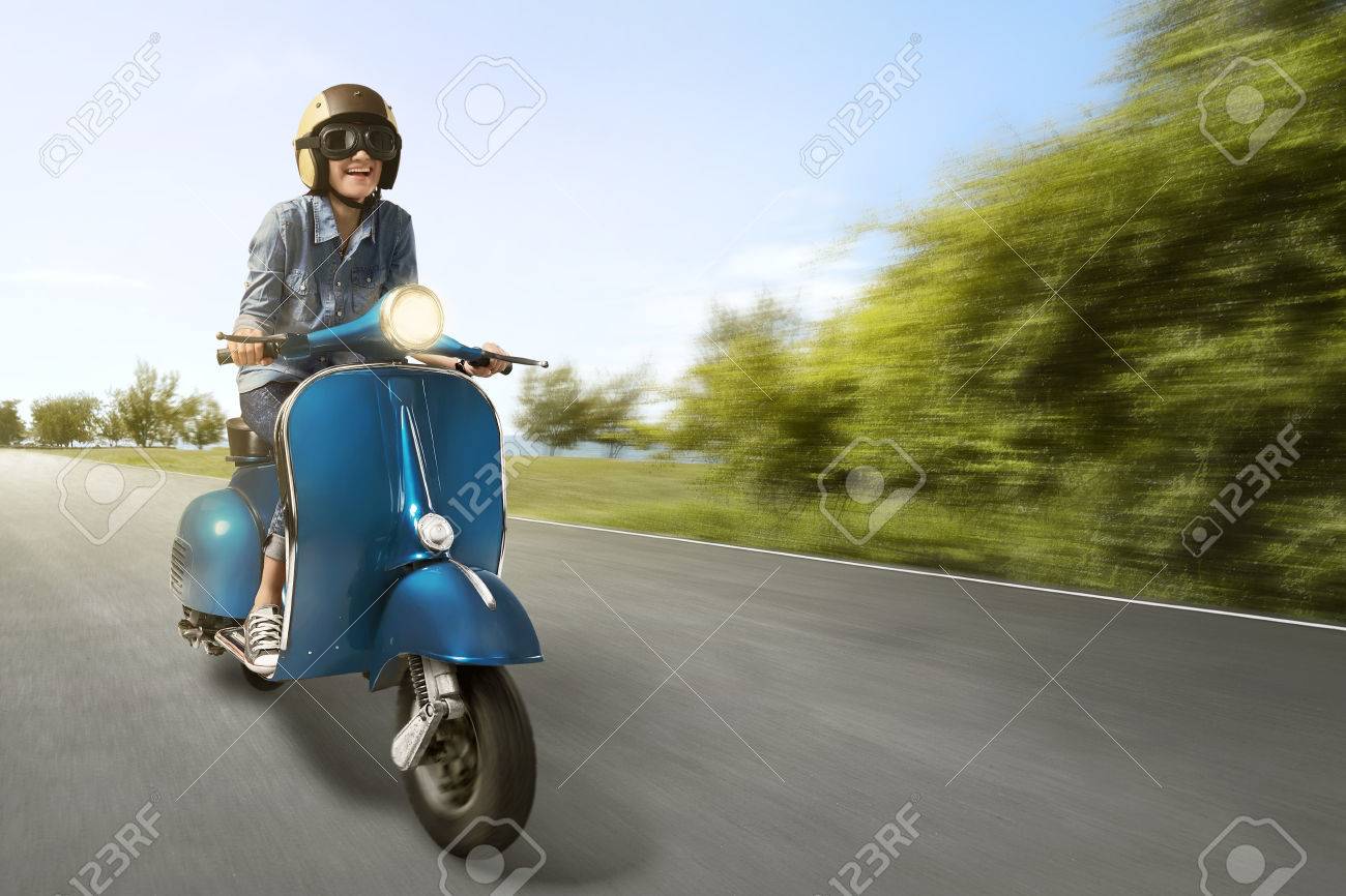 girl riding vespa scooter