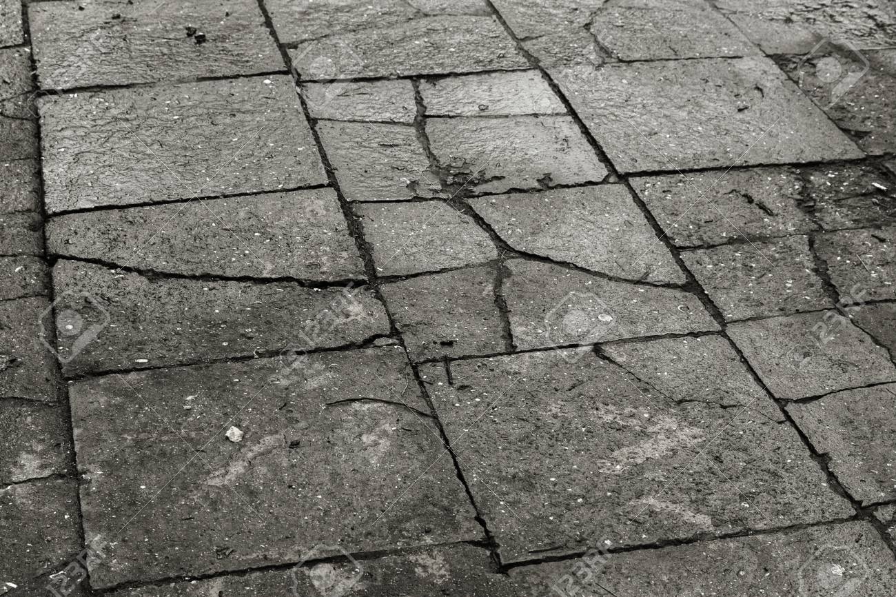Damaged Asphalt Road With Potholes Caused By Freeze Thaw Cycles In Winter Bad Road Broken Pavements Sidewalks On Sidewalk Pavement With Paving Slabs With Defects And Cracks Coming In Perspective Stock Photo Picture