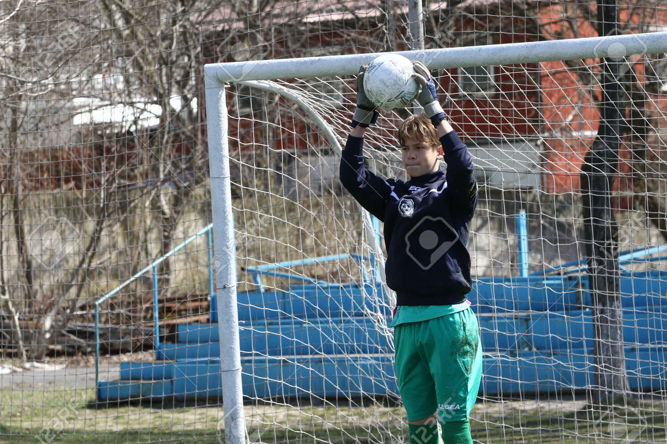 Odessa, Ukraine - April 7, 2021: Local children's football teams U-14 play on artificial grass of stadium. Football on field with artificial grass for soccer games. Children are playing football - 167820178 Odessa, Ukraine - April 7, 2021: Local children's football teams U-14 play on artificial grass of stadium. Football on field with artificial grass for soccer games. Children are playing football - 167820178