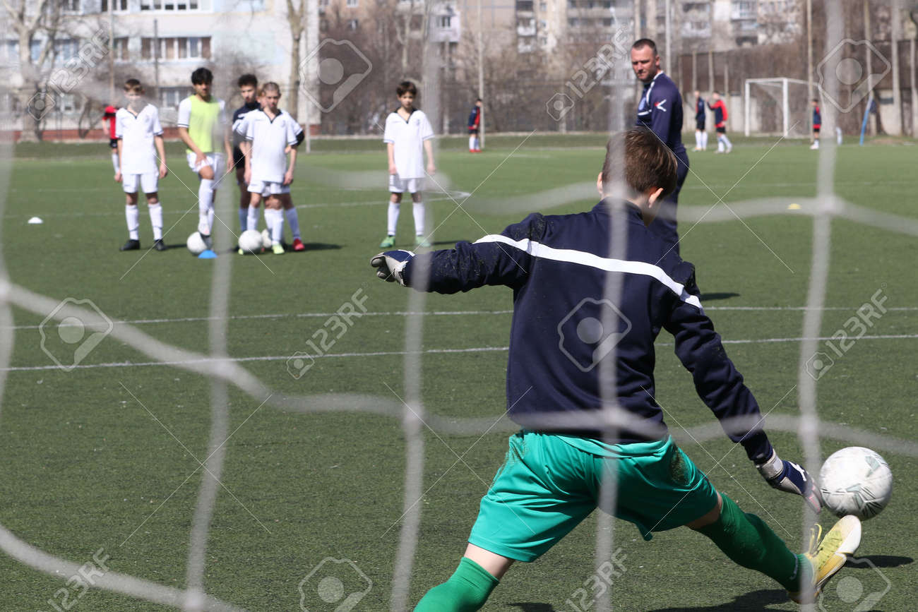 Odessa, Ukraine - April 7, 2021: Local children's football teams U-14 play on artificial grass of stadium. Football on field with artificial grass for soccer games. Children are playing football - 167820160 Odessa, Ukraine - April 7, 2021: Local children's football teams U-14 play on artificial grass of stadium. Football on field with artificial grass for soccer games. Children are playing football - 167820160