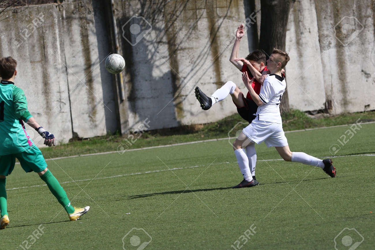 Odessa, Ukraine - April 7, 2021: Local children's football teams U-14 play on artificial grass of stadium. Football on field with artificial grass for soccer games. Children are playing football - 167820145 Odessa, Ukraine - April 7, 2021: Local children's football teams U-14 play on artificial grass of stadium. Football on field with artificial grass for soccer games. Children are playing football - 167820145