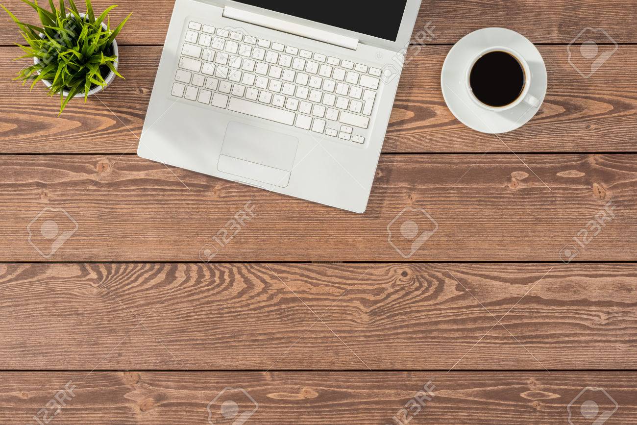 Overhead Shot Of Office Table With White Laptop Coffee Cup And