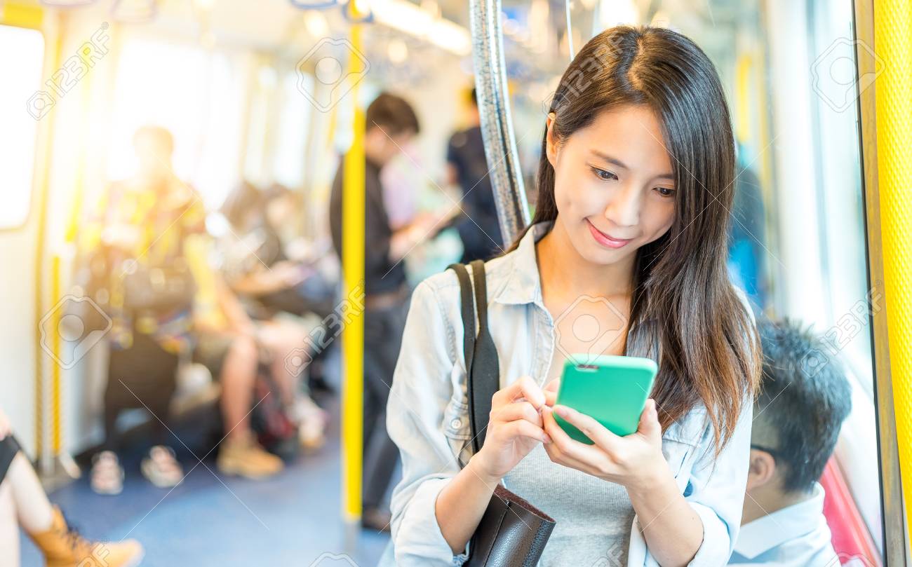 woman working on mobile phone inside train compartment stock photo phone girl