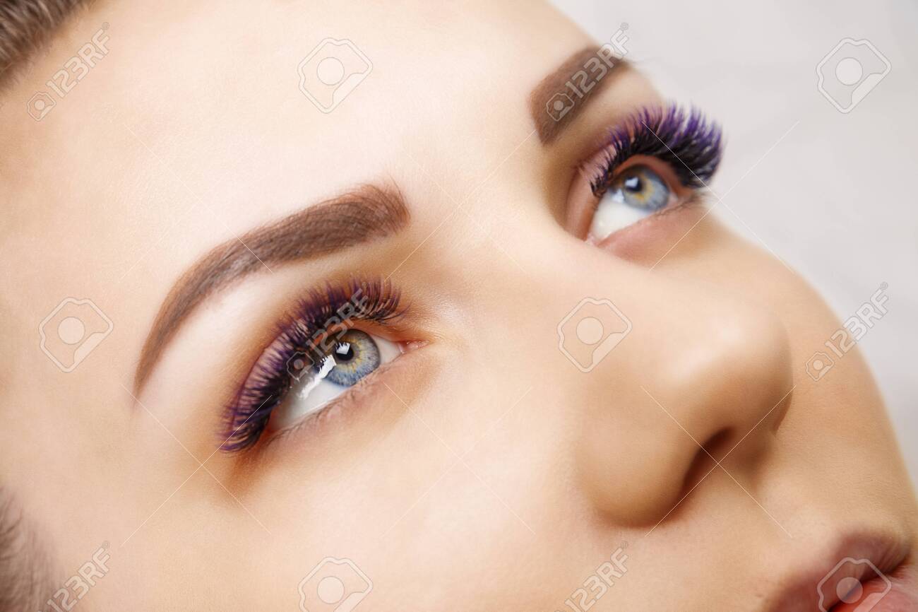 Eyelash Extension Procedure. Woman Eye with Long Blue Eyelashes. Ombre effect. Close up, selective focus. - 120994716 Eyelash Extension Procedure. Woman Eye with Long Blue Eyelashes. Ombre effect. Close up, selective focus. - 120994716
