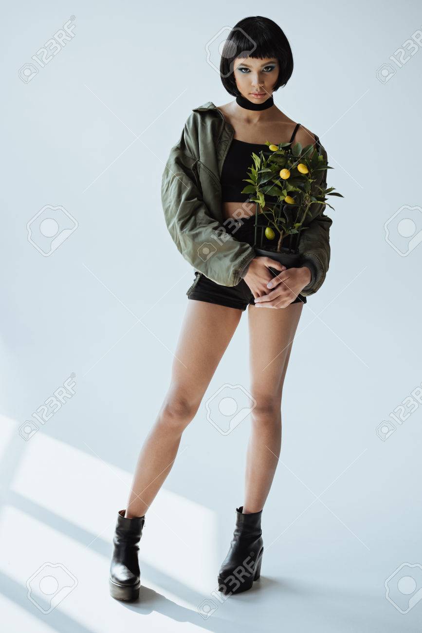 Stylish African American Girl With Bob Haircut Holding Houseplant