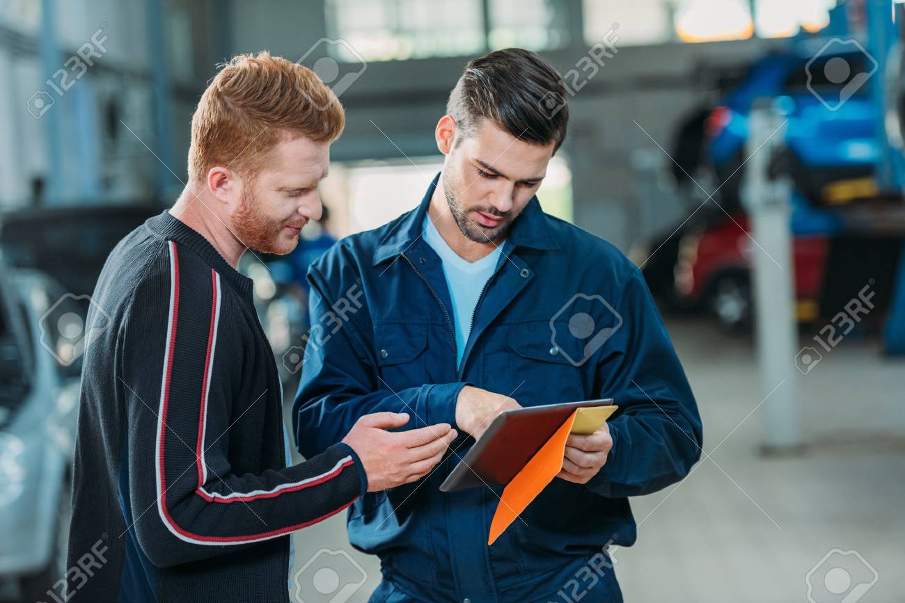 Automechanic and client looking digital tablet - 89246773 Automechanic and client looking digital tablet - 89246773
