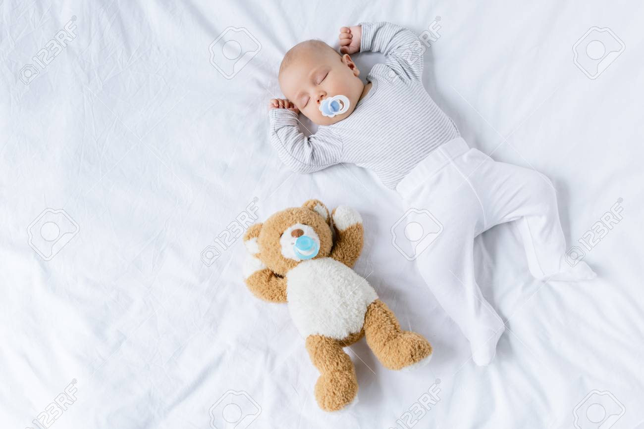 sleeping baby with toy - 95685461 sleeping baby with toy - 95685461