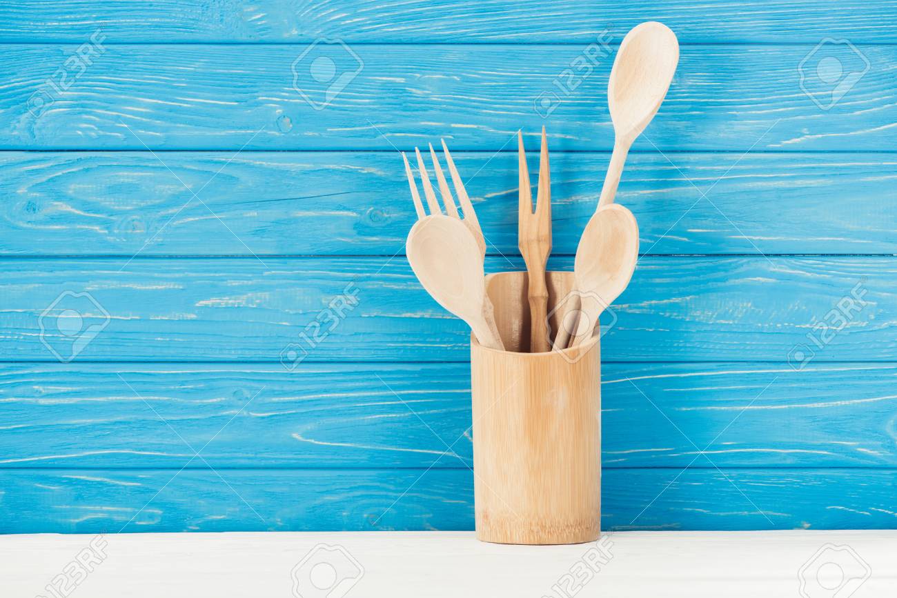 Closeup Shot Of Kitchen Utensils In Front Of Blue Wooden Wall