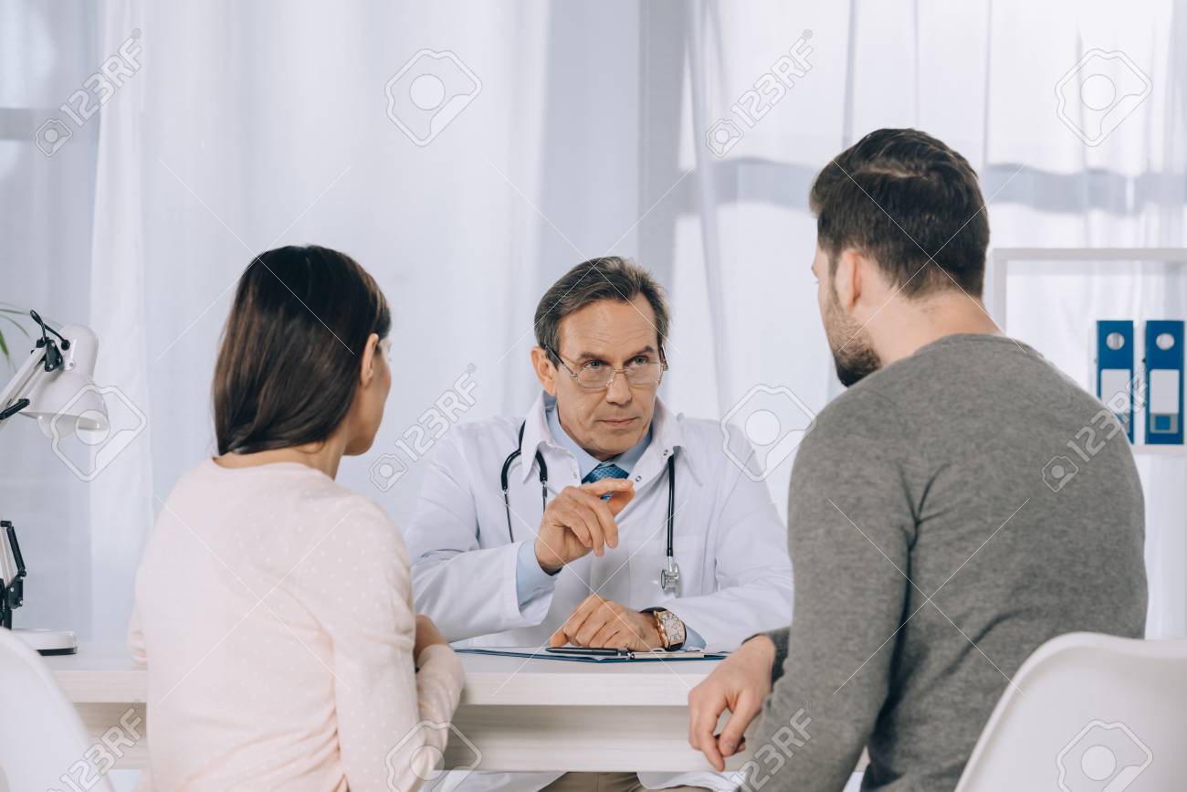 Wife And Husband Listening Doctor At picture